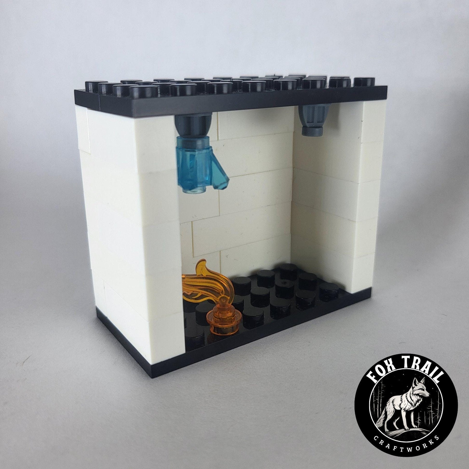 Left‑side view of single fire sprinkler demo kit showing flame element and activated blue water crystal in the exclusive sprinkler block.