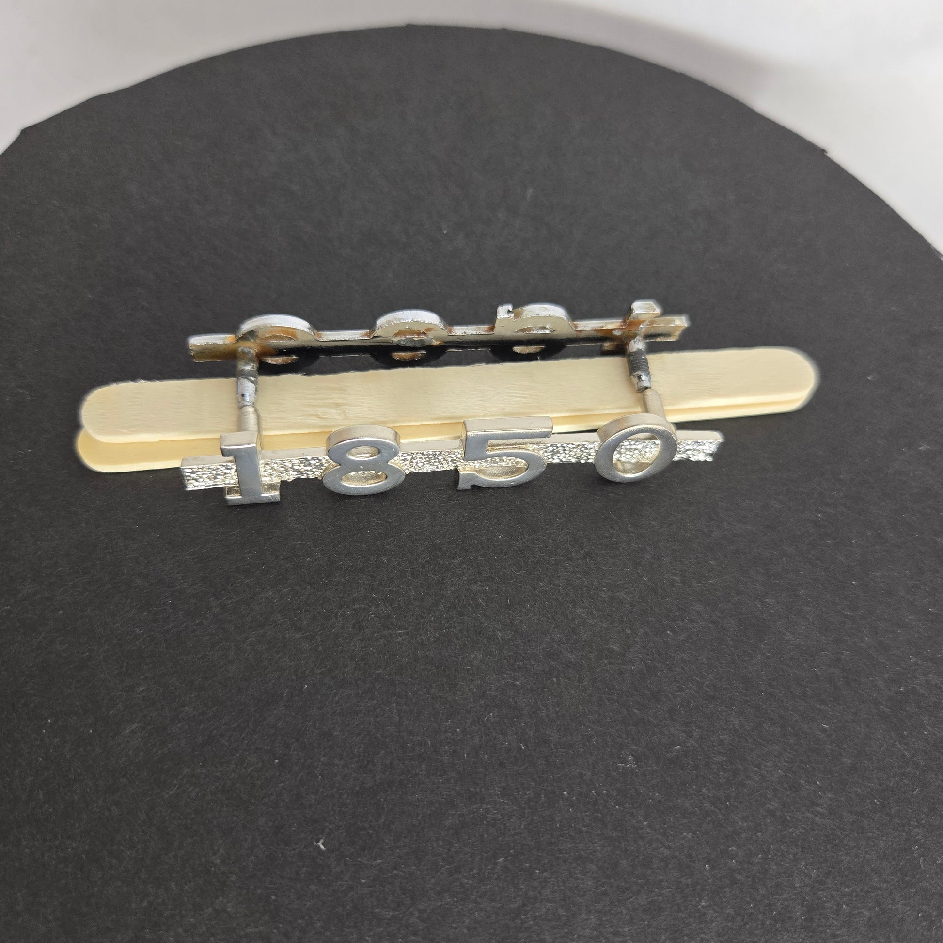 Comparison of original MGA 1600 emblem pins with MGA 1850 emblem pins, showing exact positioning and fit for easy replacement on classic MGAs.