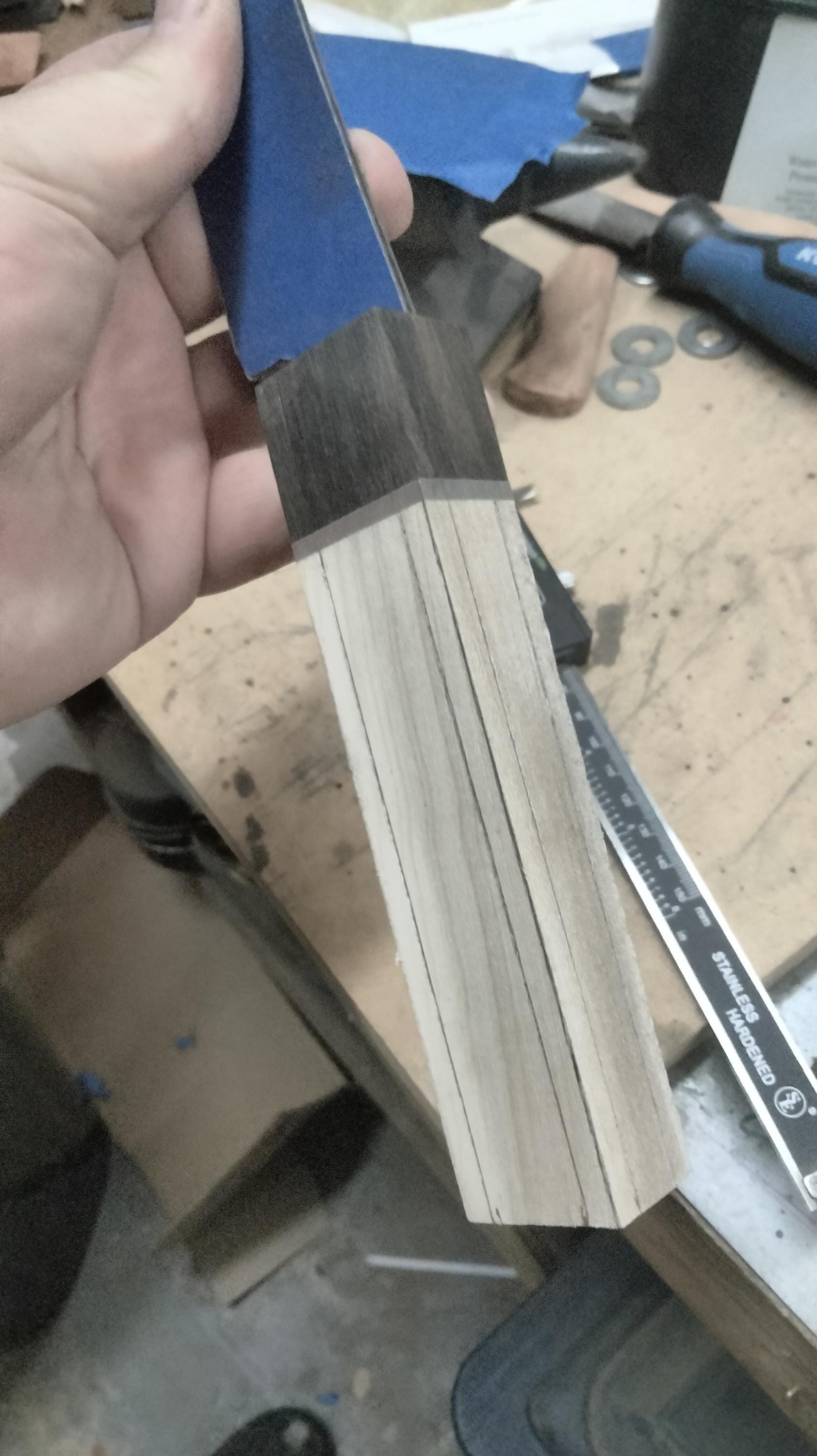 Photo of partially assembled San‑Mai knife handle, Gaboon ebony and silver maple secured over hidden tang prior to final shaping and finishing.