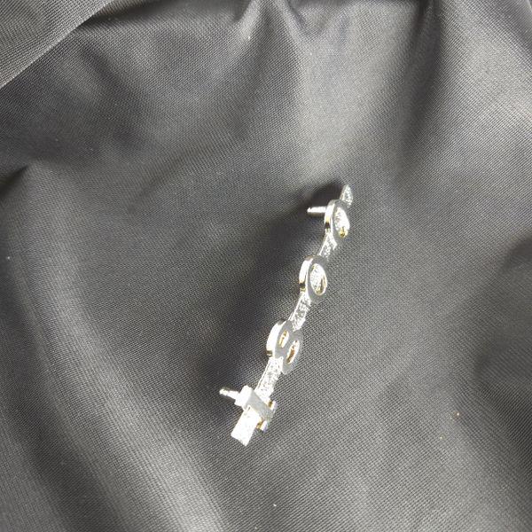 Top‑down view of MGA 1800 emblem on black cloth, showcasing smooth curvature, accurate proportions, and polished finish.