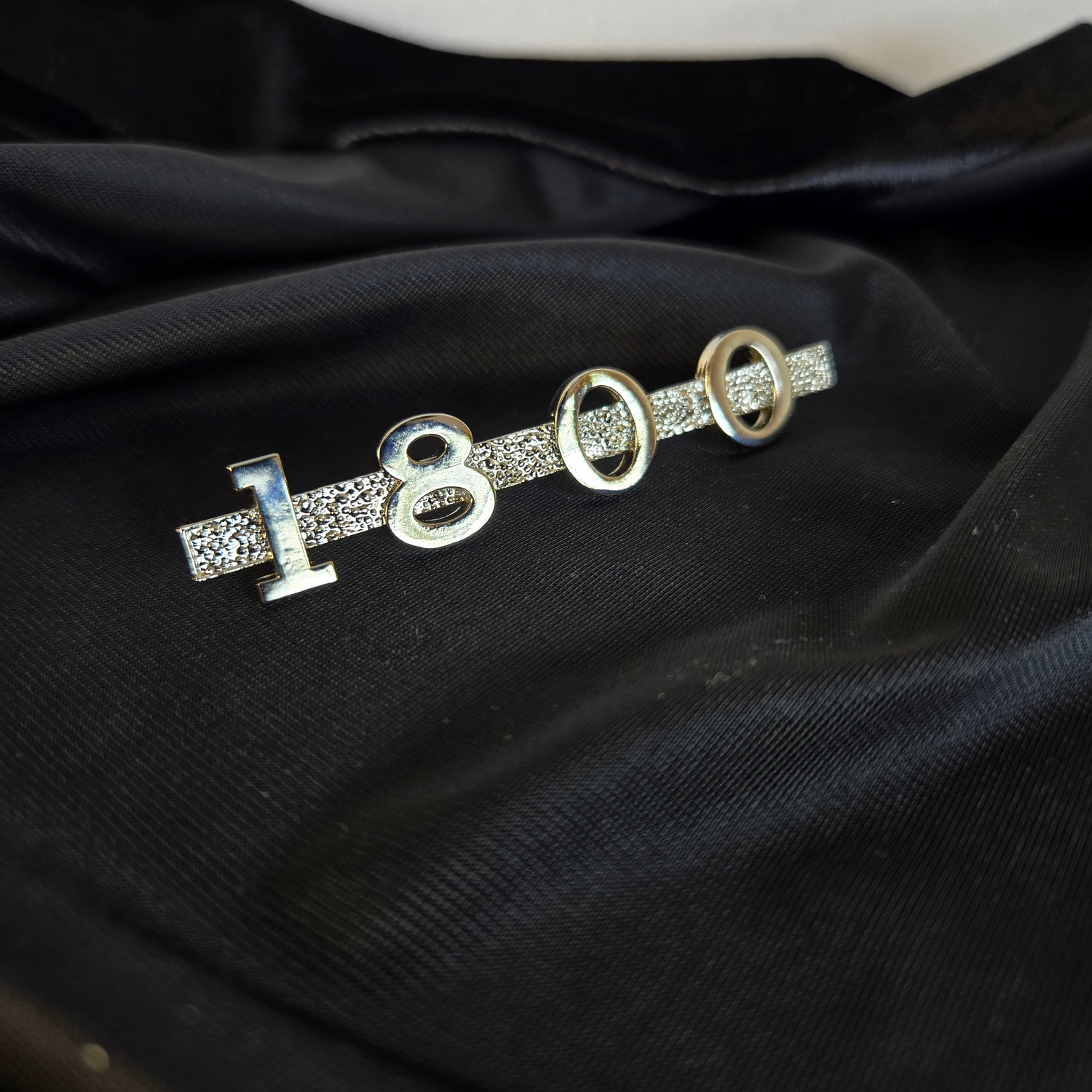 Custom 3D‑printed 1800 emblem nickel plated with a shiny finish, designed in the style of the original MGA 1600 car emblem.