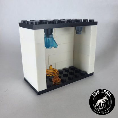 Left‑side view of single fire sprinkler demo kit showing flame element and activated blue water crystal in the exclusive sprinkler block.