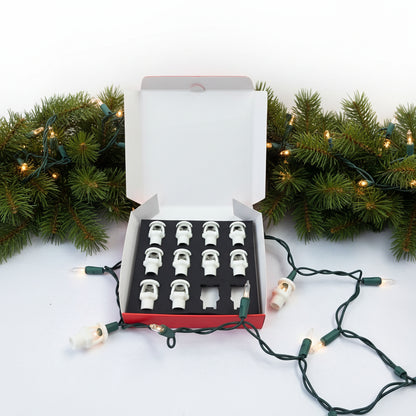 Fire sprinkler string light covers displayed in box with mini-light strand and greenery.