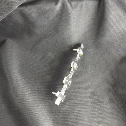 Top‑down view of MGA 1800 emblem on black cloth, showcasing smooth curvature, accurate proportions, and polished finish.